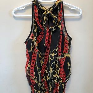 Black gold and red sleeveless blouse.